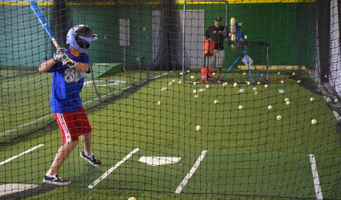 Boy practicing batting in a Nashville area batting cage