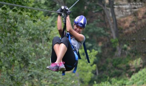 Girl Zip LIning in one of Nashville's Parks